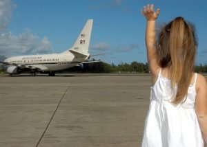 Photo of child waving to plane - The UCCJEA helps resolve interstate child custody disputes