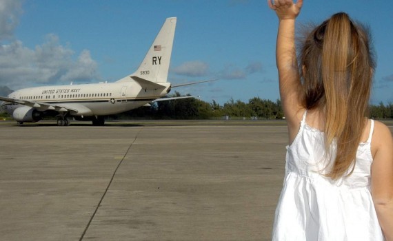Photo of child waving to plane - The UCCJEA helps resolve interstate child custody disputes