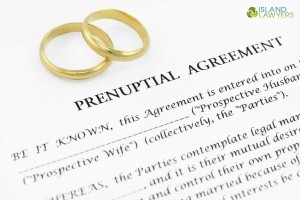 Wedding rings pictured over a prenuptial agreement